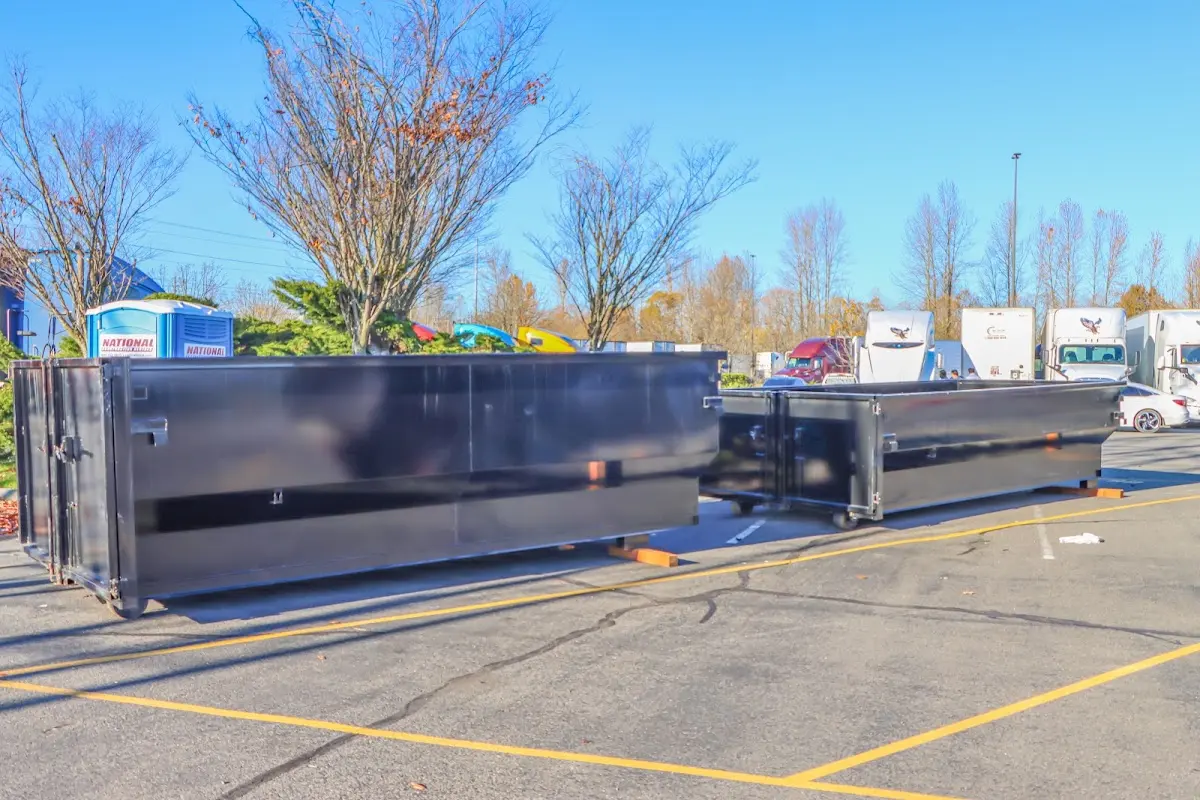 Professional dumpster rental service with roll-off container on residential driveway in Perryville